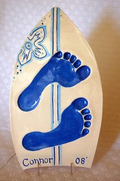 a blue and white surfboard with two feet on it