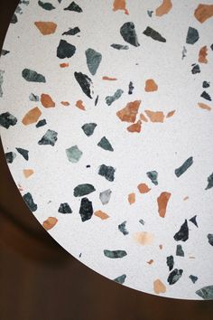 a white table topped with lots of brown and black rocks