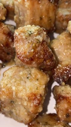 closeup of meatballs with sauce on them sitting on a white plate, ready to be eaten