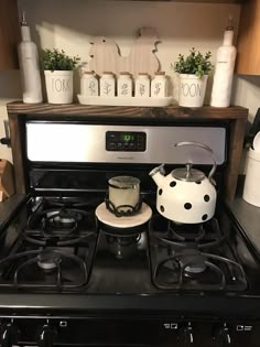 a stove top oven sitting next to a counter with pots and pans on it