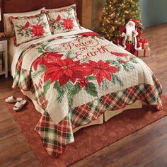 a christmas themed bed with poinsettis and stockings on the floor next to a tree