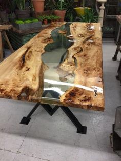 a table made out of wood with metal legs and an interesting design on the top