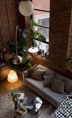 a living room filled with lots of furniture and plants on top of it's windowsill