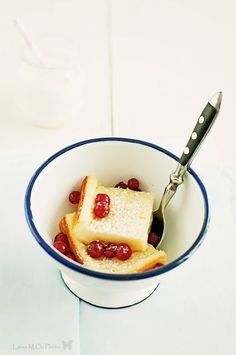 a bowl filled with bread and jelly pudding