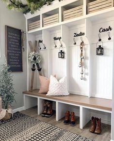 the entryway is decorated for christmas with white benches and wooden crates on either side