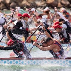 a group of people rowing on top of a body of water