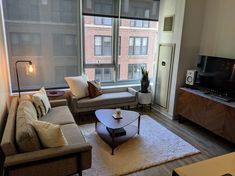 a living room filled with furniture and a flat screen tv