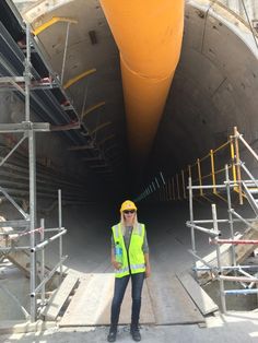 a construction worker standing in front of a tunnel