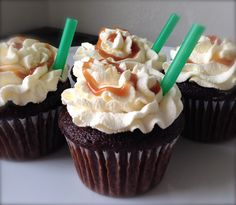 three cupcakes with white frosting and green plastic straws