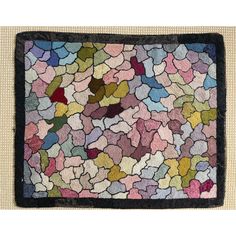 a multicolored area rug with black border on the bottom, and an image of several different colored shapes