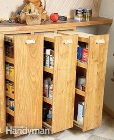 a wooden cabinet filled with lots of food and condiments on top of it