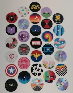 a bunch of different colored and black stickers on a white surface with various designs