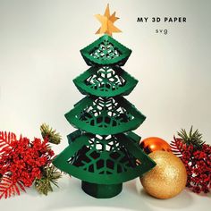 a green plastic christmas tree next to red and gold ornaments on a white background with the title my 3d paper svyg