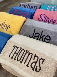 towels with names on them sitting on the floor