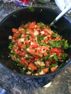 a bowl filled with chopped vegetables on top of a counter