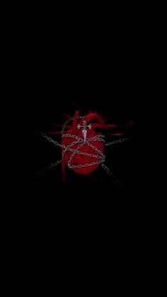 a black background with a red heart and chain on the bottom right corner, in the middle of the image