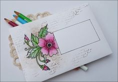 an envelope decorated with flowers and crayons