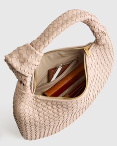 This Italian Leather Handwoven Slouchy Shoulder Bag is the epitome of luxury and style. Handcrafted from the finest Italian leather, this bag features a clean handwoven design that adds a touch of sophistication to any outfit. The slouchy silhouette gives it a relaxed and effortless vibe, perfect for everyday use or special occasions. With ample space and two pockets for all your essentials, this shoulder bag is both practical and chic. Make a statement with this versatile piece that will elevate your look and stand the test of time.  | Quince | Women's Italian Leather Handwoven Slouchy Shoulder Bag in Taupe Woven Leather Bag, Sheep Leather, Handle Bag, Elevate Your Look, Leather Working, Quince, Italian Leather, Top Handle, Leather Bag