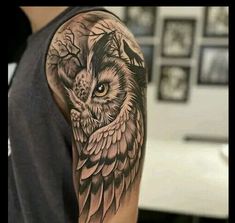 an owl tattoo on the arm and shoulder