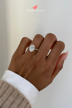 a woman's hand with a diamond ring on it