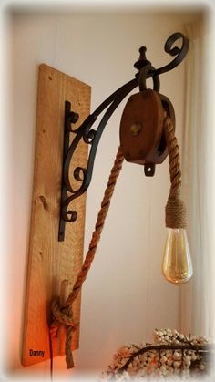 a light that is on the wall next to a wooden board and some lightshade