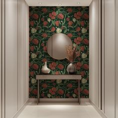 a hallway with a mirror, vases and flowers on the wall next to it