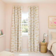 a bedroom with pink walls and white curtains