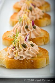 small appetizers are arranged on a white plate