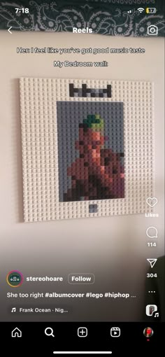 a lego photo hanging on the wall in front of a computer screen with an image of a man