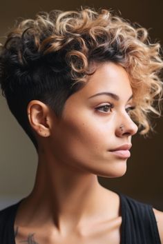 The disconnected curly undercut brings a touch of excitement to any appearance. This short hairstyle with curly hair complements various curl patterns, whether they are relaxed waves or tight coils. Click here to check out more cute short curly haircuts & hairstyles trending right now. Curly Pompadour Women Short Hair, Curly Tapered Haircut Women, Perm Mohawk, Curly Short Pixie Haircut, Short Curly Hair Shaved Side, Undercut Curly Hair Woman, Short Curly Haircuts Pixie, Mohawk Women Short