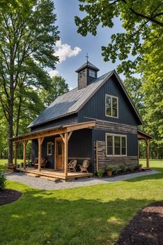 a small house with a porch and covered patio in the middle of a grassy area