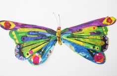 a colorful butterfly is hanging on the wall