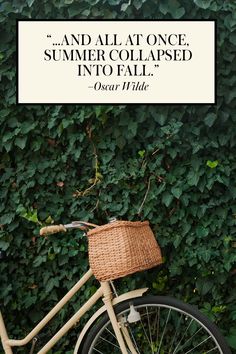 a bicycle parked next to a green wall with a quote above it that reads, and all at once, summer collapsed into fall