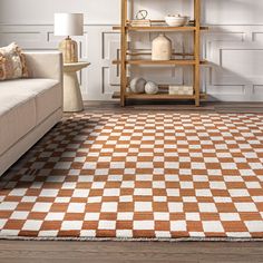 an orange and white checkered rug in a living room