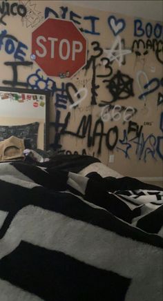 a bedroom with graffiti all over the walls