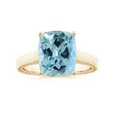 a cushion cut blue topaz ring in yellow gold