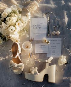 the bride's shoes and jewelry are laid out on the table