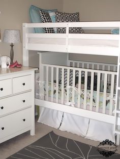 a white bunk bed sitting in a bedroom next to a dresser and chest of drawers