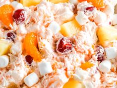 a salad with fruit and marshmallows is shown in this close up photo