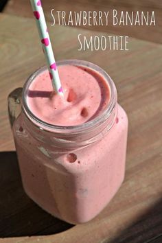 a pink smoothie in a mason jar with a straw