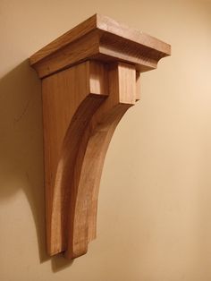 a wooden shelf mounted to the side of a wall