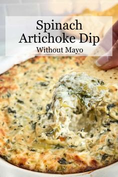 spinach artichoke dip in a white bowl with a tortilla chip