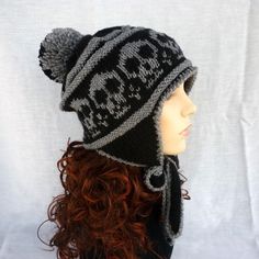 a mannequin head wearing a black and gray knitted hat with skulls on it