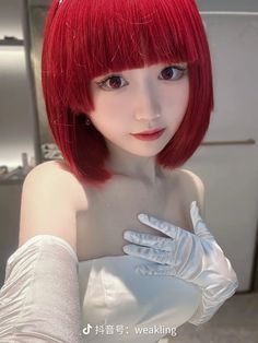 a woman with red hair wearing white gloves