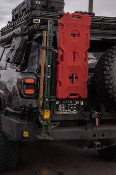 the back end of a vehicle with luggage strapped to it