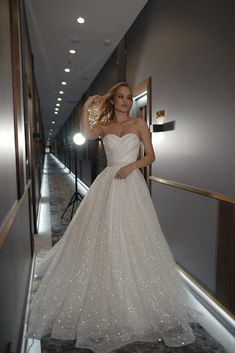 a woman in a wedding dress posing for the camera