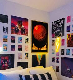 a bedroom with posters on the wall and a bed