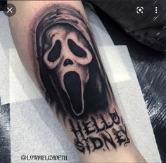 a black and white photo of a person with a ghost mask on their arm that says hello spider