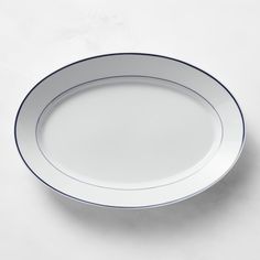 an empty white plate with blue trim on it