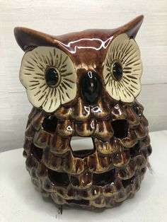 an owl figurine sitting on top of a table